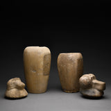 Two Egyptian Limestone Canopic Jars and Two Egyptian Canopic Jar Lids of Hapy